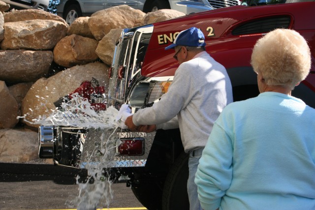 Former Chief Richard &quot;Cappy&quot; Champlin christening new Engine 2 at the open house held on 10/1/05.